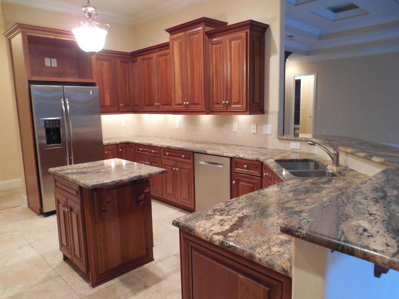 4498 Stonebridge Road Destin, FL 32541 - Photo 2 of 6 a kitchen with stainless steel appliances granite countertop a sink a stove and a refrigerator
