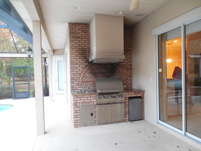4498 Stonebridge Road Destin, FL 32541 - Photo 5 of 6 a kitchen with stainless steel appliances granite countertop a stove and a refrigerator