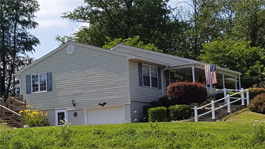284 Ferncliff Road Rices Landing, PA 15357 - Photo 3 of 17 Vinyl sided with shutters, featuring a basement walk-in and access to the garage and steps to the back porch.