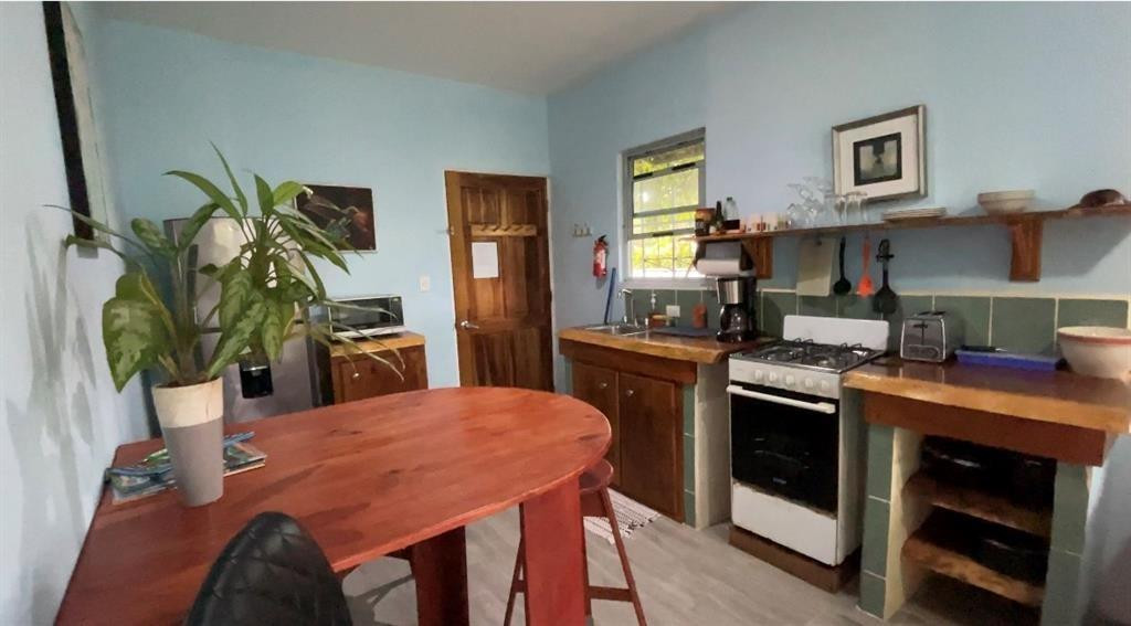 Undisclosed Address undefined, undefined 00000 - Photo 15 of 35 a kitchen with a table chairs and a stove