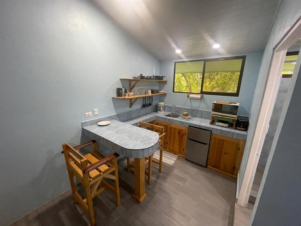 Undisclosed Address undefined, undefined 00000 - Photo 18 of 35 a kitchen with a table chairs and a window