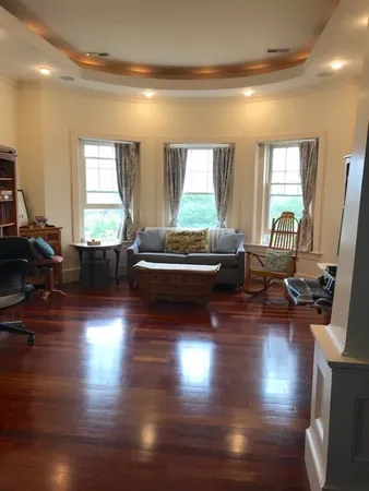 a living room with dining room and wooden floor
