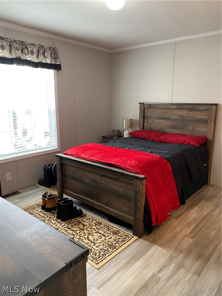 2700 Brookpark Road, Unit 626 Cleveland, OH 44134 - Photo 6 of 32 Bedroom featuring ornamental molding and light hardwood / wood-style flooring