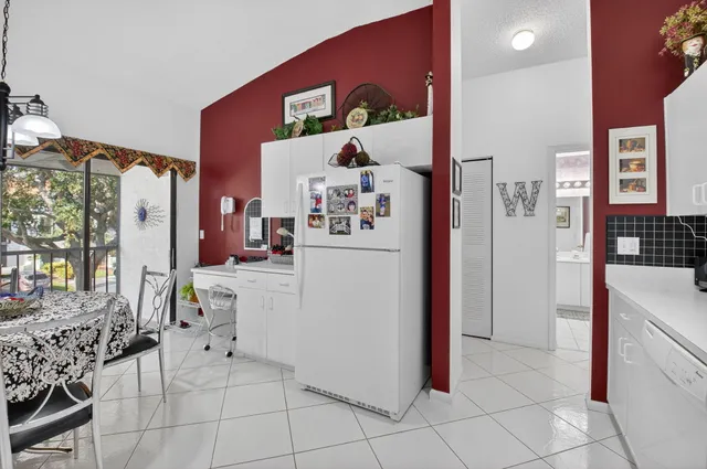 a view of kitchen with furniture and refrigerator