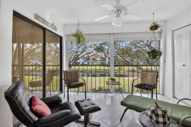 a living room with furniture and a floor to ceiling window