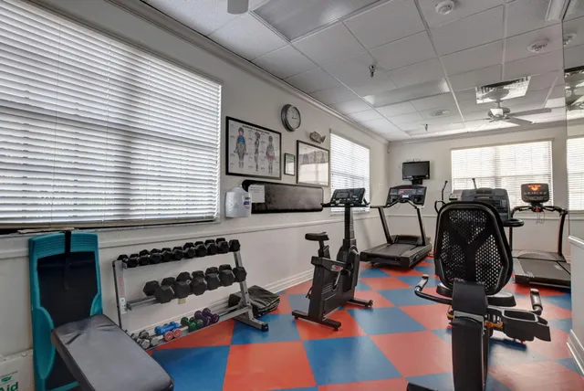 a room with gym equipment and window