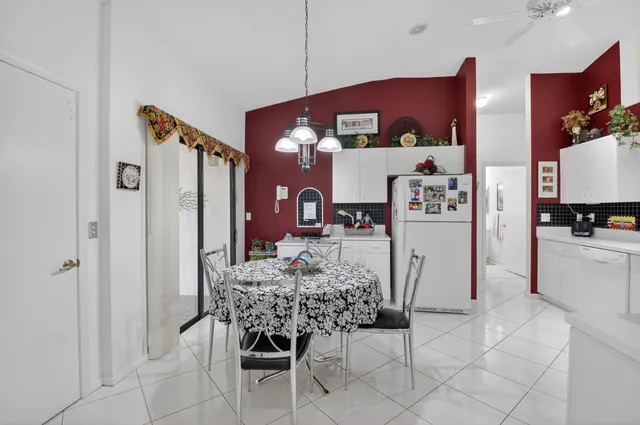 a view of kitchen with refrigerator and furniture