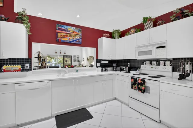 a kitchen with stainless steel appliances granite countertop a stove and a sink