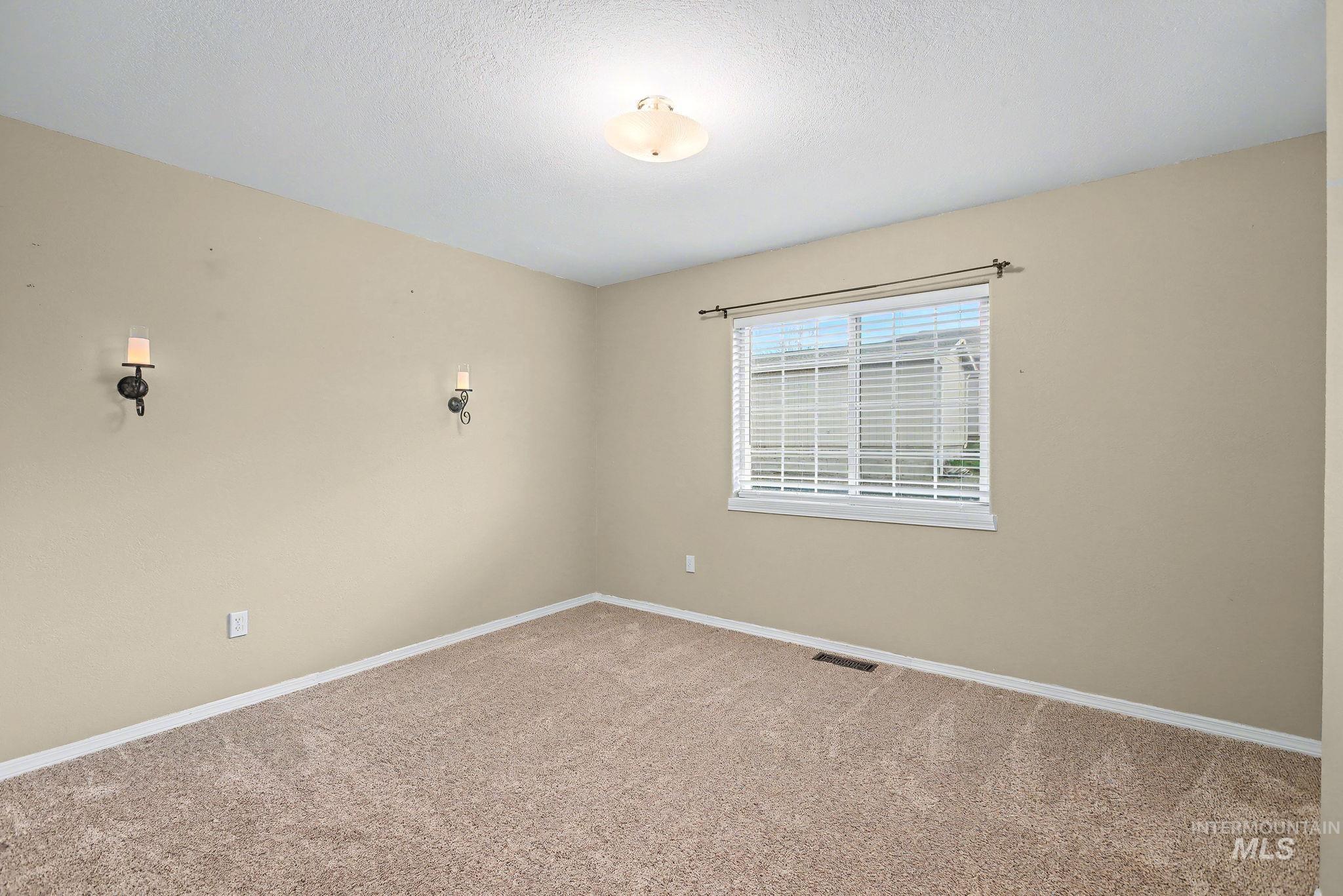 2242 Chukar Lane Clarkston, WA 99403 - Photo 28 of 41 Carpeted empty room featuring baseboards and a textured ceiling