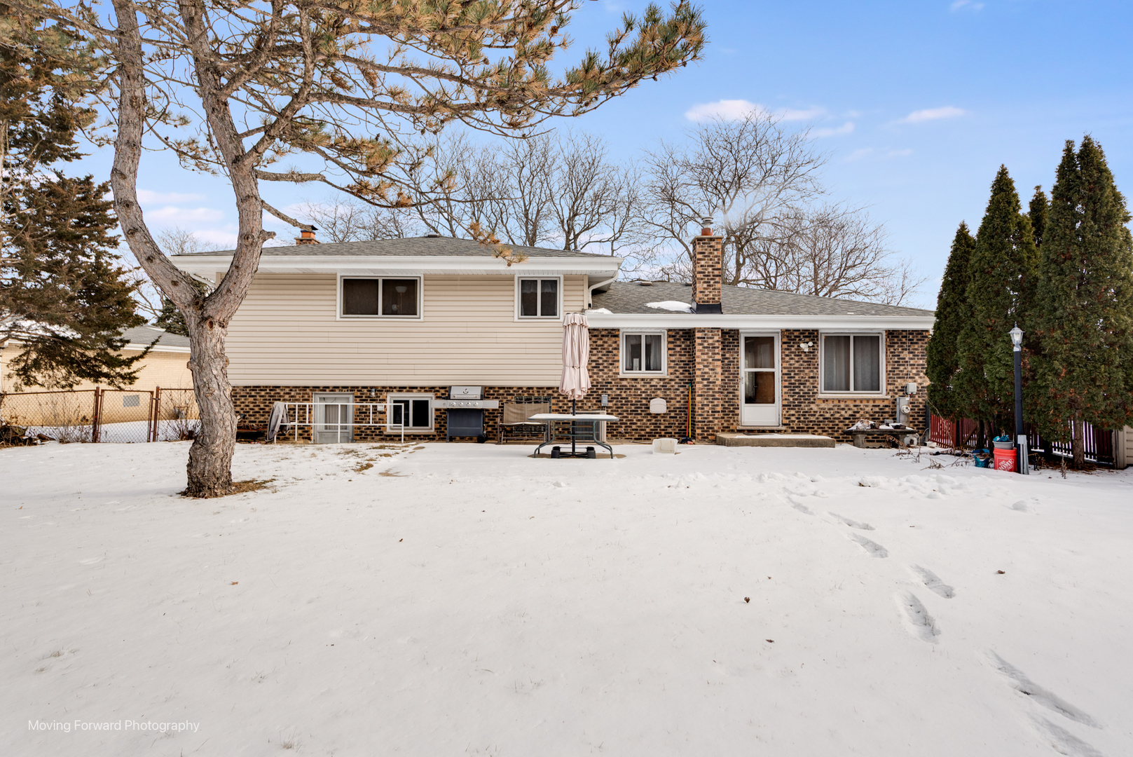 539 West Eggerding Drive Addison, IL 60101 - Photo 24 of 29 a view of a white house with a yard covered in snow