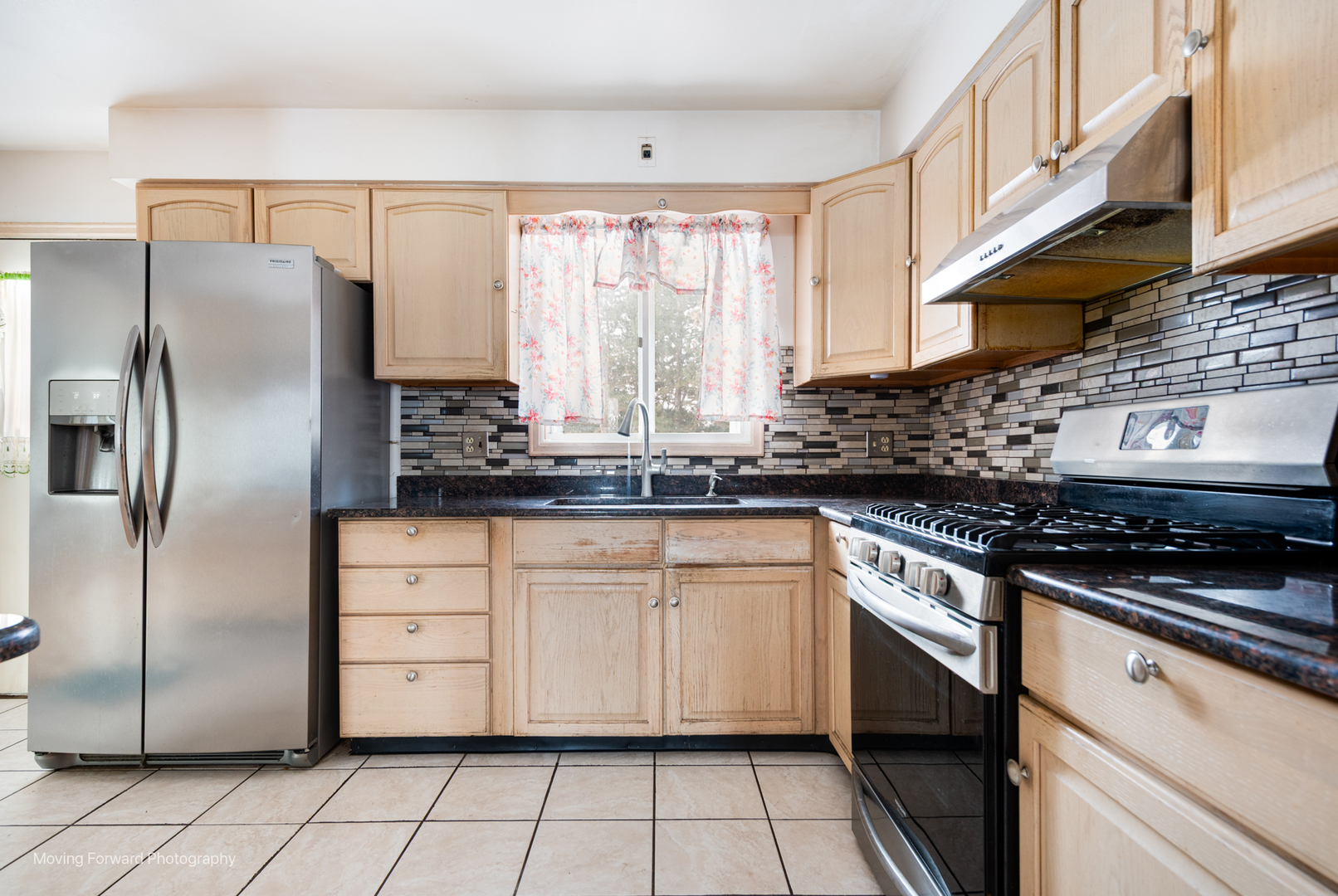 539 West Eggerding Drive Addison, IL 60101 - Photo 7 of 29 a kitchen with stainless steel appliances granite countertop a refrigerator a sink a stove and white cabinets