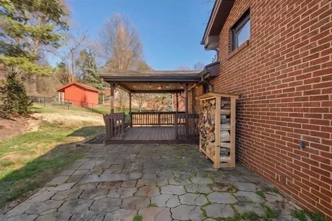 a view of an house with backyard space and patio