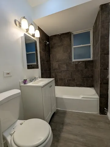 a bathroom with a toilet a sink and bathtub