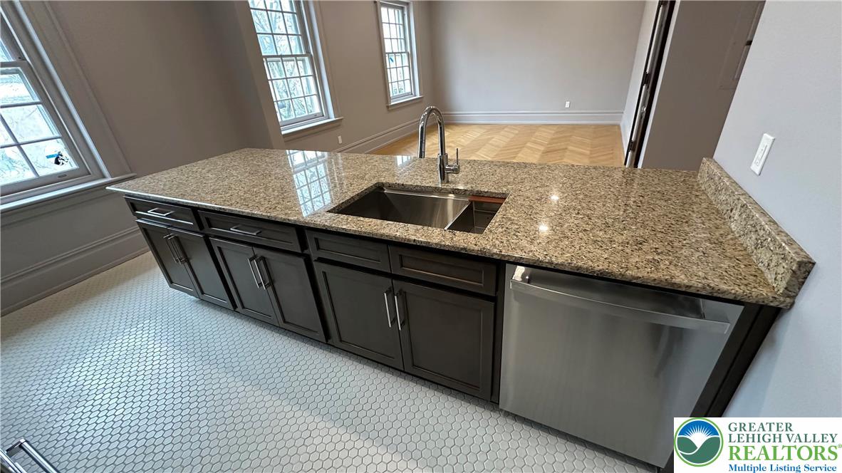 214 Spring Garden Street, Unit 3A Easton, PA 18042 - Photo 12 of 20 a kitchen with a sink and a mirror
