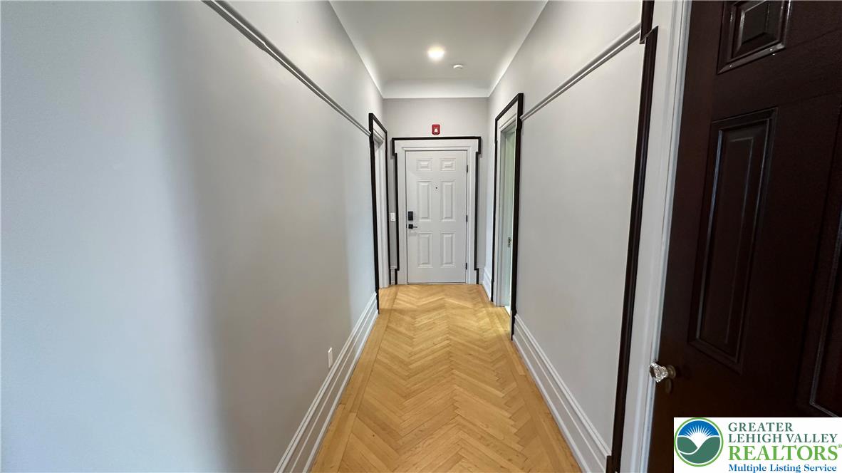 214 Spring Garden Street, Unit 3A Easton, PA 18042 - Photo 4 of 20 a view of hallway with shower and wooden floor