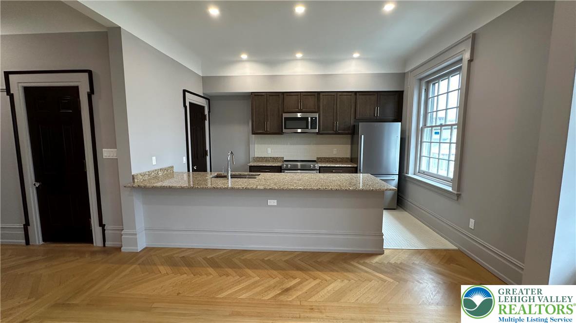 214 Spring Garden Street, Unit 3A Easton, PA 18042 - Photo 5 of 20 a view of kitchen with refrigerator and window