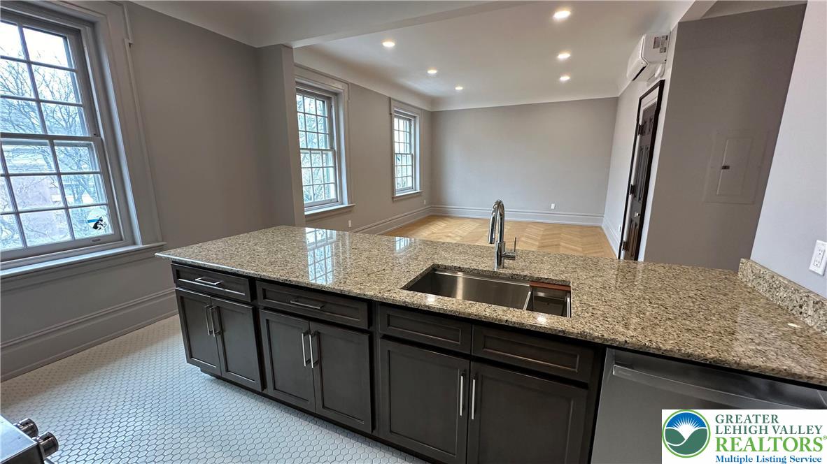 214 Spring Garden Street, Unit 3A Easton, PA 18042 - Photo 10 of 20 a kitchen with stainless steel appliances granite countertop a sink and a large window