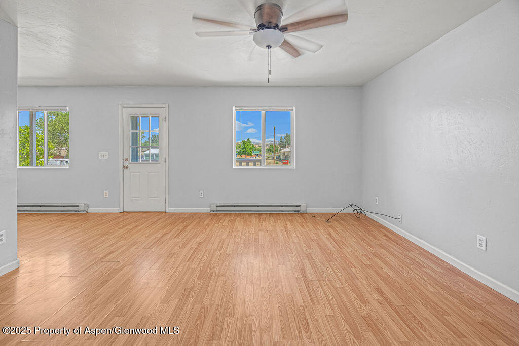 627 Lake Street Rangely, CO 81648 - Photo 12 of 44 wooden floor in an empty room with a window