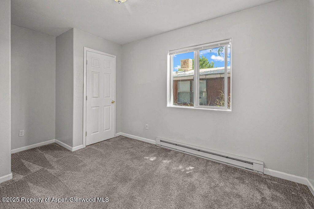 627 Lake Street Rangely, CO 81648 - Photo 17 of 44 an empty room with windows