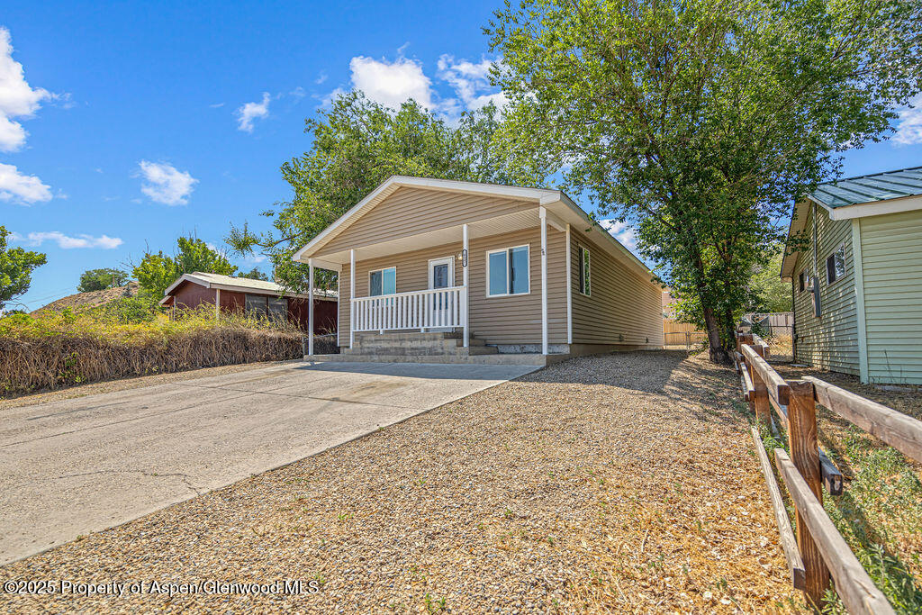 627 Lake Street Rangely, CO 81648 - Photo 2 of 44 a front view of a house with a garden