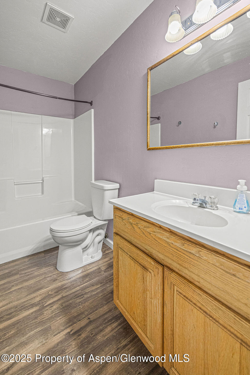 627 Lake Street Rangely, CO 81648 - Photo 33 of 44 a bathroom with a sink a toilet and a mirror