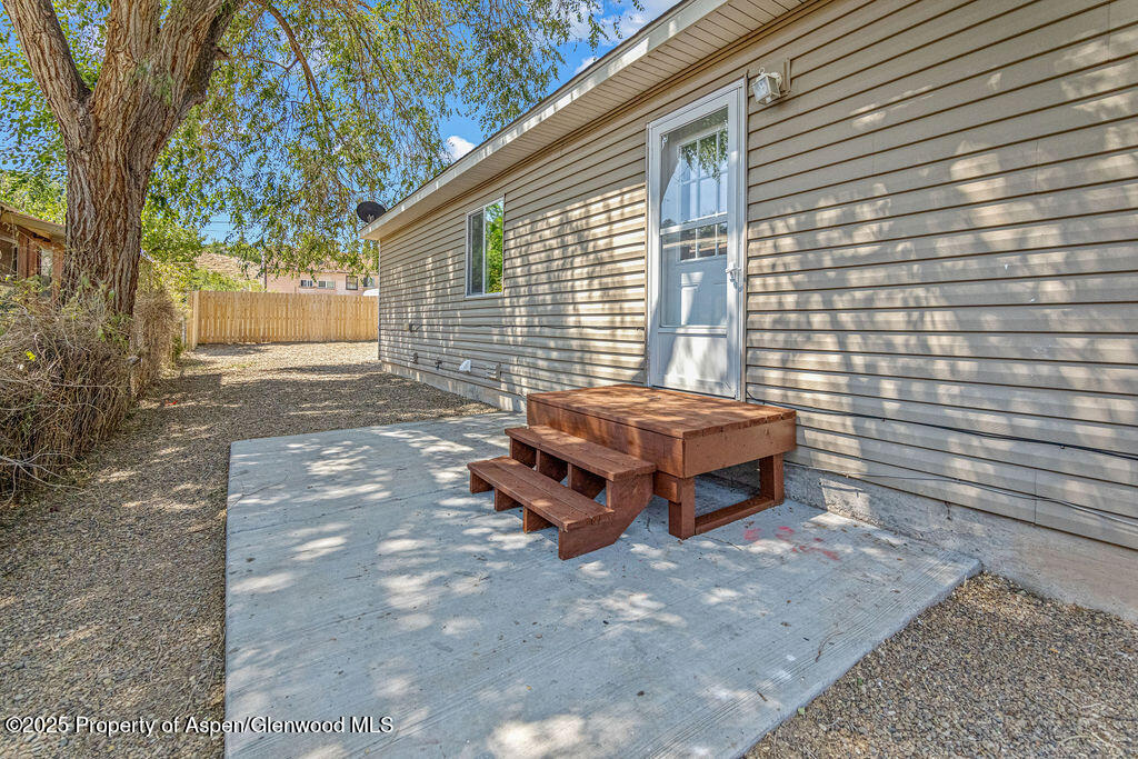627 Lake Street Rangely, CO 81648 - Photo 4 of 44 a backyard of a house with a small yard and large tree