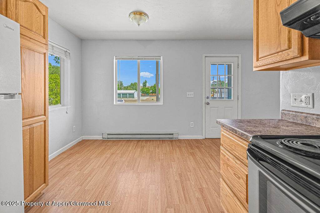 627 Lake Street Rangely, CO 81648 - Photo 7 of 44 an empty room with wooden floor and window