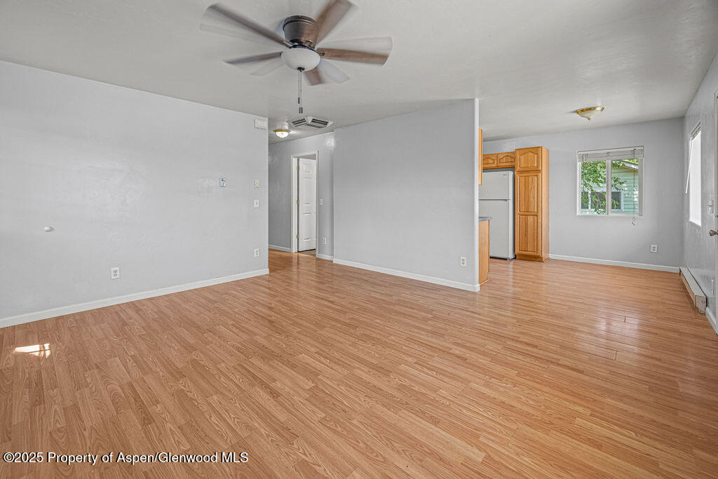 627 Lake Street Rangely, CO 81648 - Photo 10 of 44 wooden floor in an empty room with a window