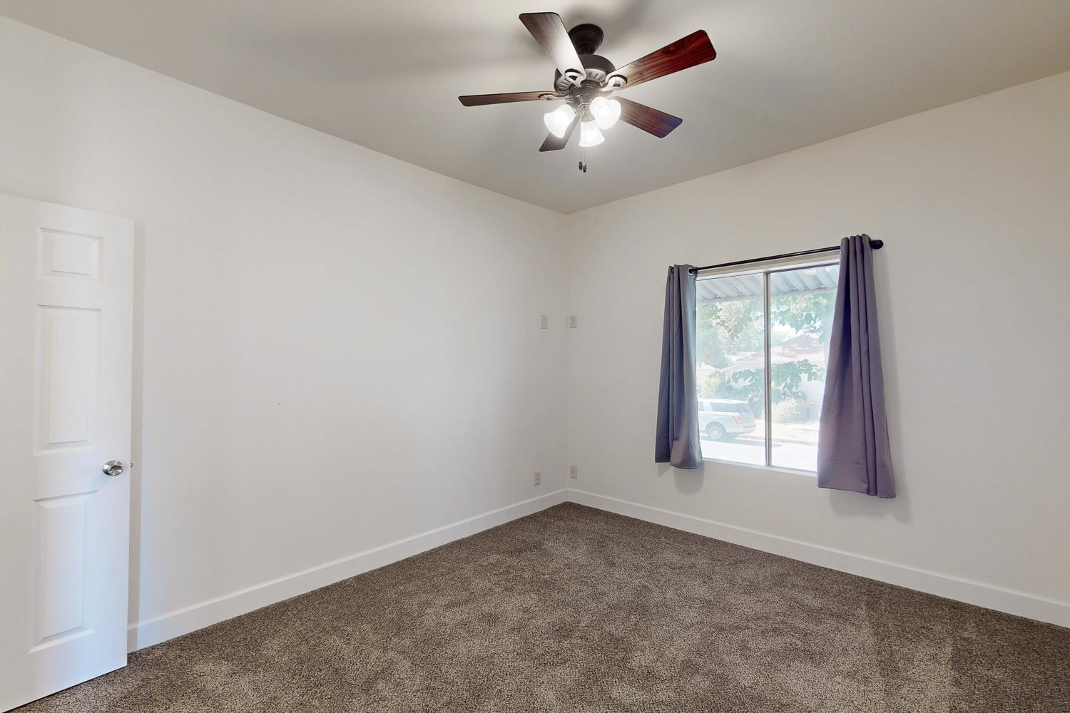 1585 Sycamore Street Gridley, CA 95948 - Photo 18 of 69 an empty room with a window and a fan