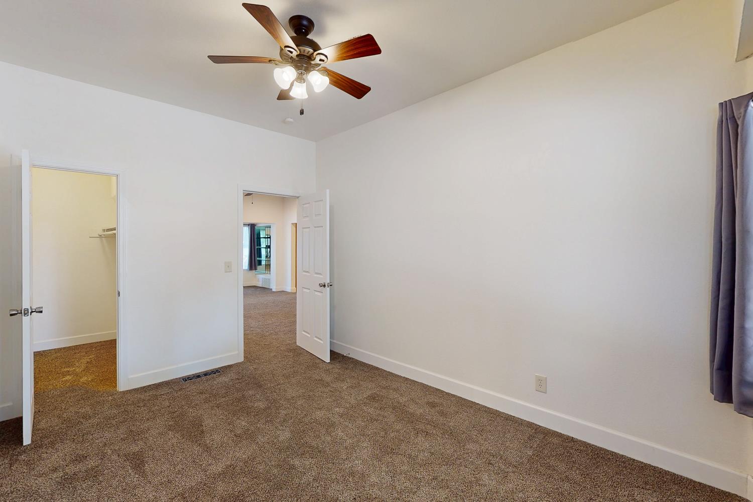 1585 Sycamore Street Gridley, CA 95948 - Photo 23 of 69 an empty room with closet and a ceiling fan
