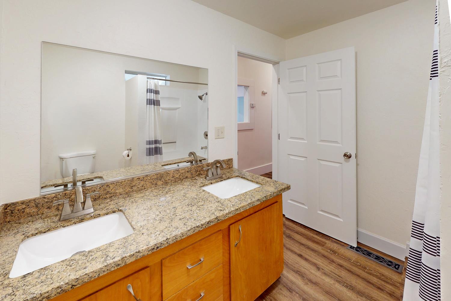 1585 Sycamore Street Gridley, CA 95948 - Photo 28 of 69 a bathroom with a granite countertop sink and a mirror