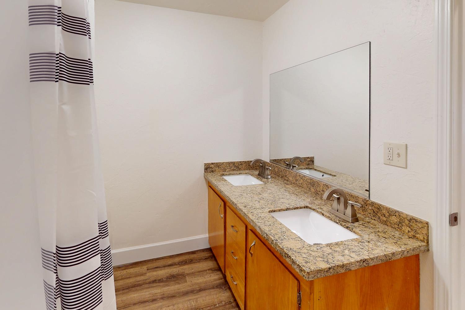 1585 Sycamore Street Gridley, CA 95948 - Photo 29 of 69 a bathroom with a granite countertop sink and a mirror
