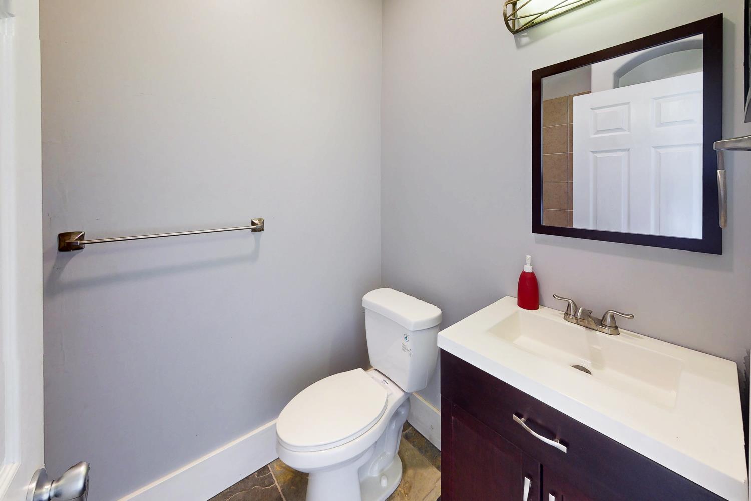 1585 Sycamore Street Gridley, CA 95948 - Photo 30 of 69 a bathroom with a toilet sink and mirror