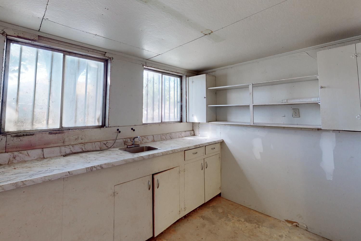 1585 Sycamore Street Gridley, CA 95948 - Photo 38 of 69 a bathroom with a granite countertop sink and a large mirror
