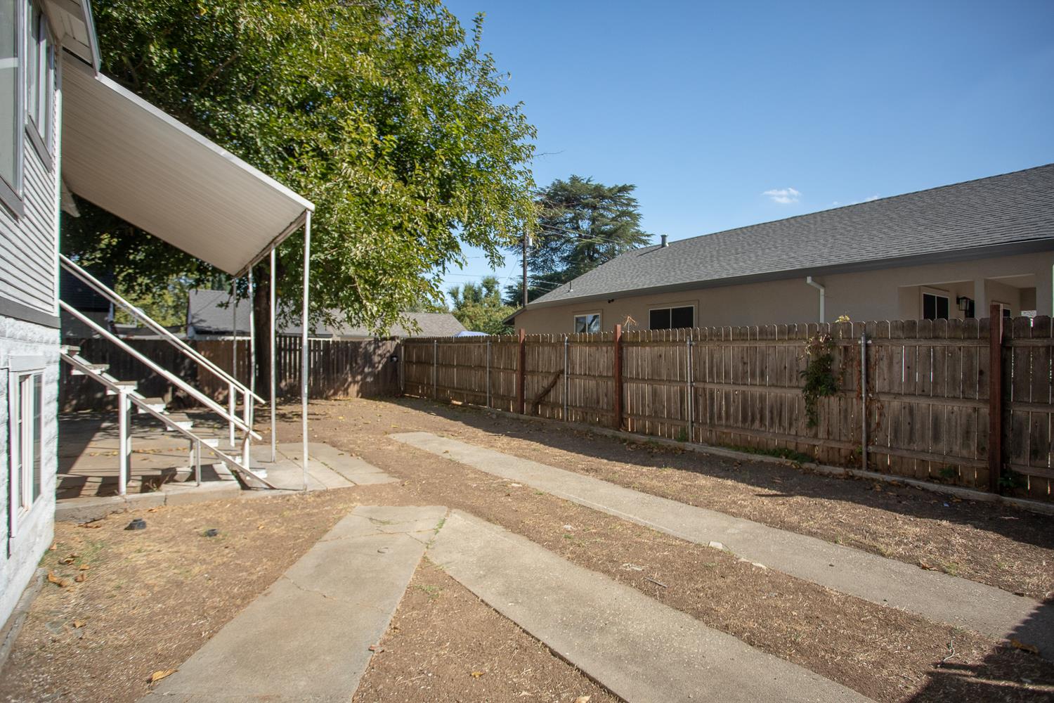 1585 Sycamore Street Gridley, CA 95948 - Photo 67 of 69 a view of backyard with wooden fence and large trees