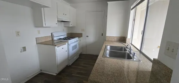 a kitchen that has a sink and a stove