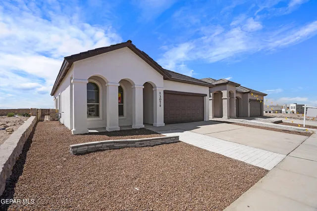 a living room with furniture kitchen view and a chandelier