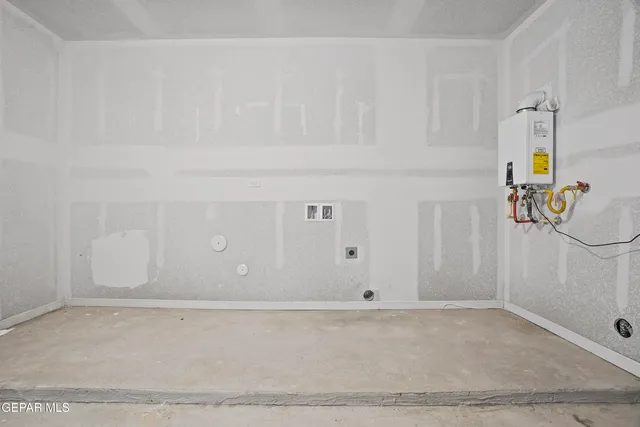 a kitchen with stainless steel appliances cabinets and wooden floor