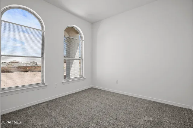 a kitchen with granite countertop a refrigerator and a stove top oven