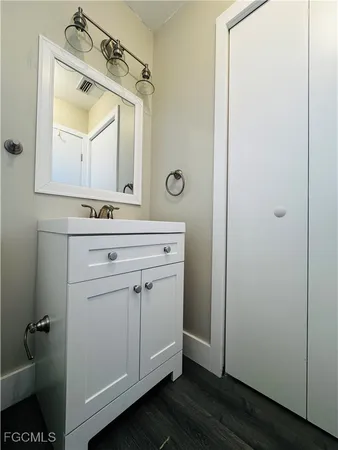 a bathroom with a mirror sink and vanity