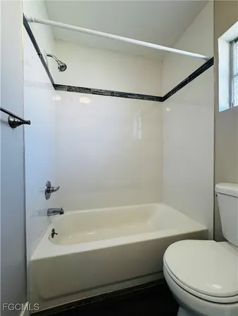 a white bath tub sitting next to a white toilet and sink
