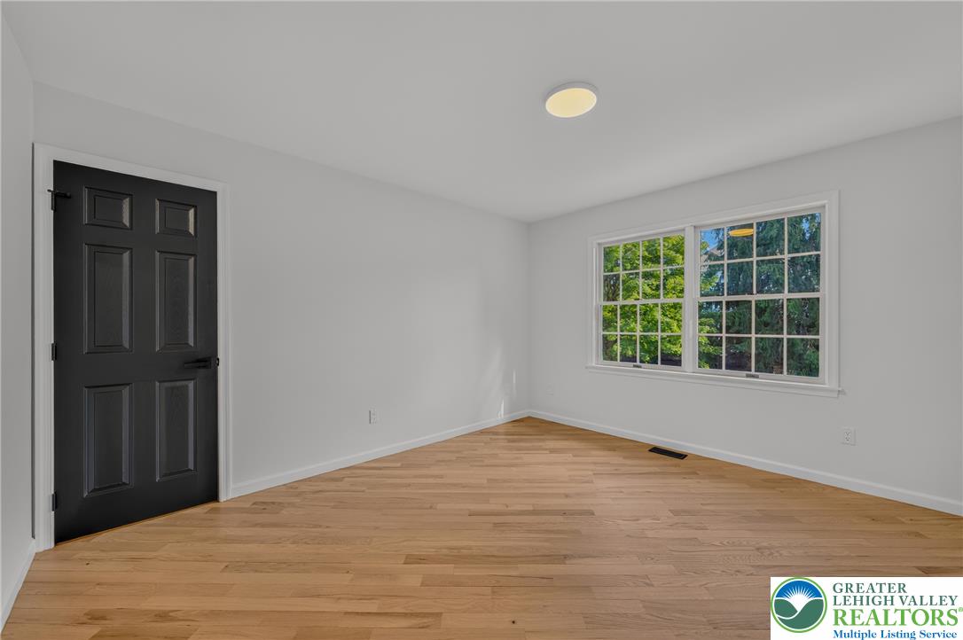 3130 Muirfield Road Center Valley, PA 18034 - Photo 36 of 63 Rich hardwood flooring anchors this versatile space illuminated by a classic multi-lite window.