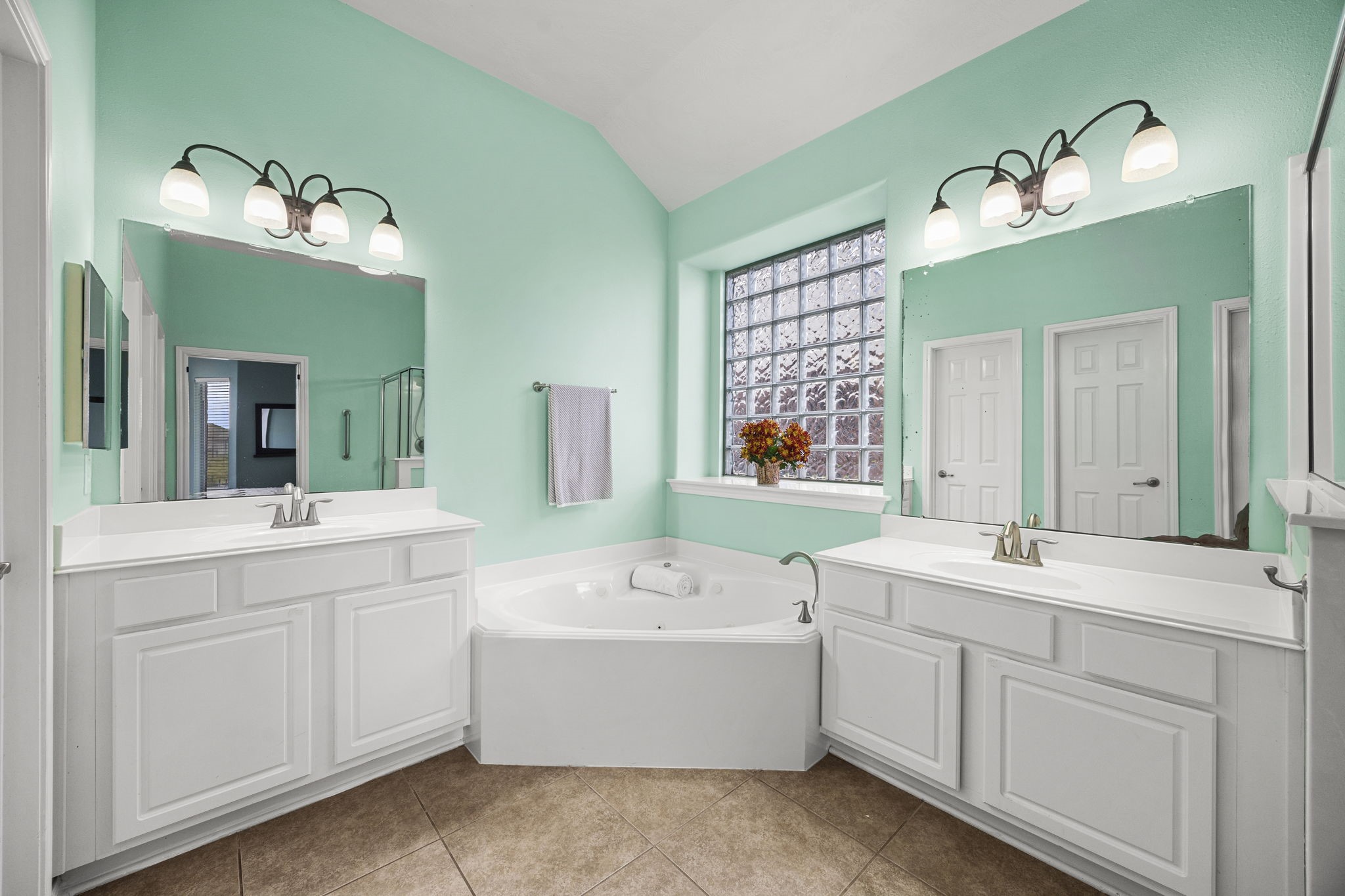 2202 Winchester Lake Rosenberg, TX 77471 - Photo 20 of 31 Primary bath has his and her sinks and a corner whirlpool tub. Obscured glass block window for soft light and privacy.