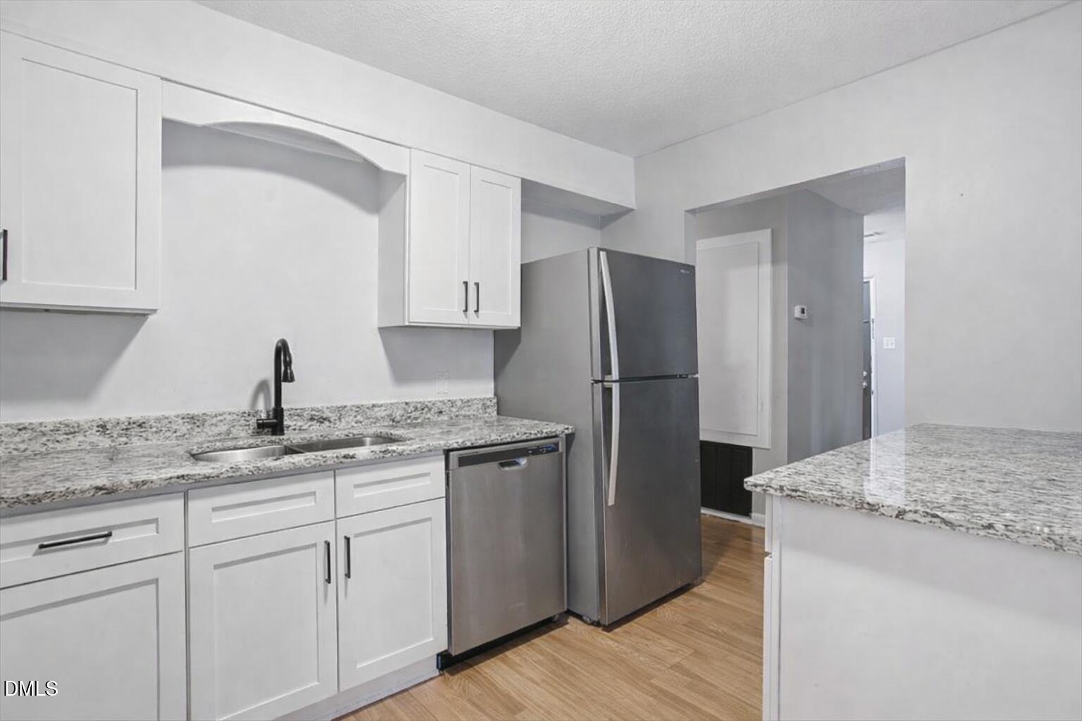 5130 Flint Ridge Place Raleigh, NC 27609 - Photo 14 of 22 a kitchen with appliances a sink and cabinets