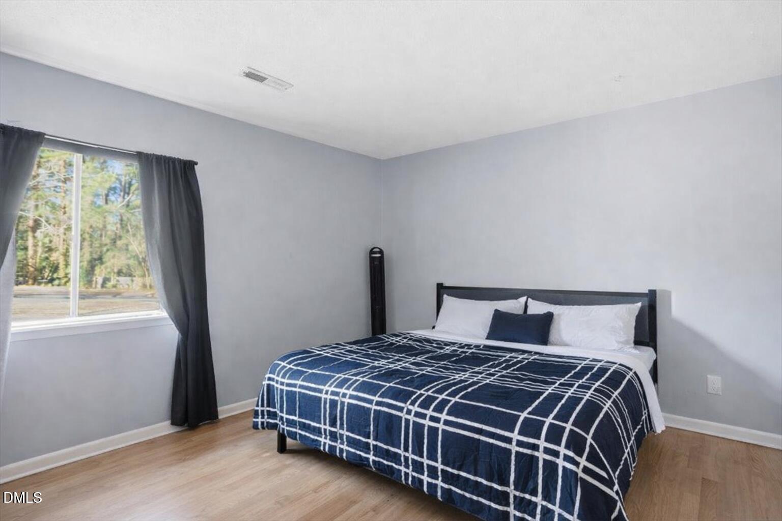 5130 Flint Ridge Place Raleigh, NC 27609 - Photo 16 of 22 a bedroom with a large bed and a window