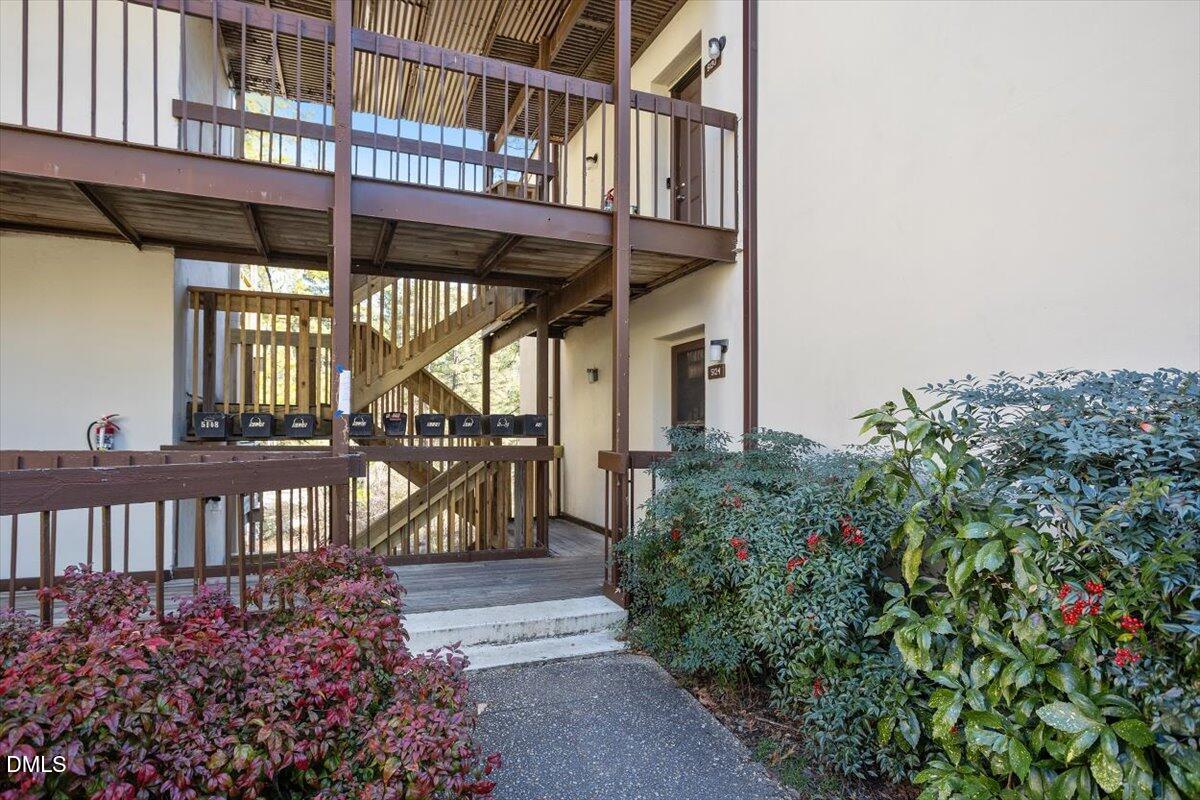5130 Flint Ridge Place Raleigh, NC 27609 - Photo 3 of 22 a view of a house with a small yard and flower plants