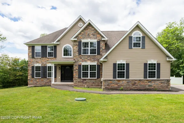 a front view of a house with a yard