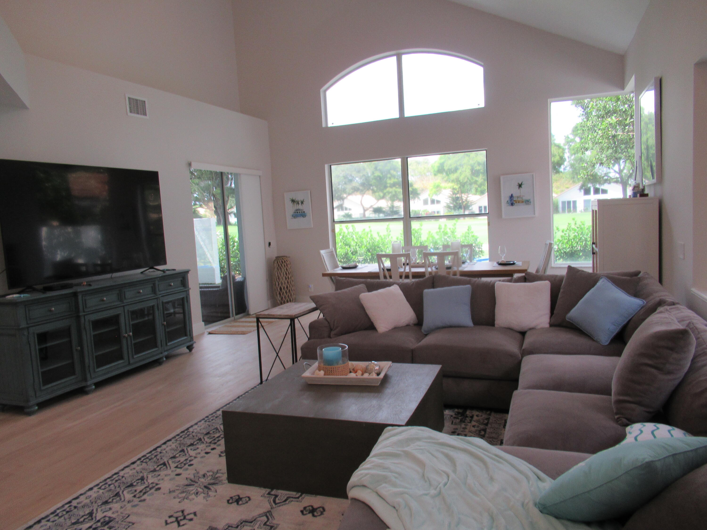 2237 Northwest 53rd Street Boca Raton, FL 33496 - Photo 12 of 76 a living room with furniture and a flat screen tv