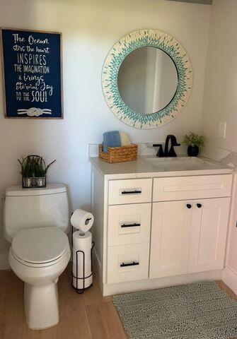2237 Northwest 53rd Street Boca Raton, FL 33496 - Photo 23 of 76 a bathroom with a toilet a sink and a mirror