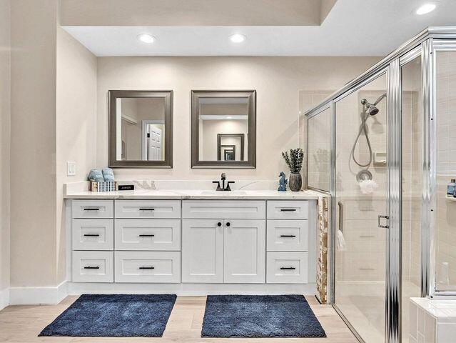 2237 Northwest 53rd Street Boca Raton, FL 33496 - Photo 31 of 76 a spacious bathroom with a double vanity sink a mirror and a shower